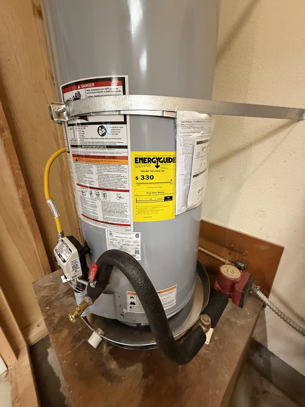 Tank water heater connected with a flexible gas line and shutoff valve